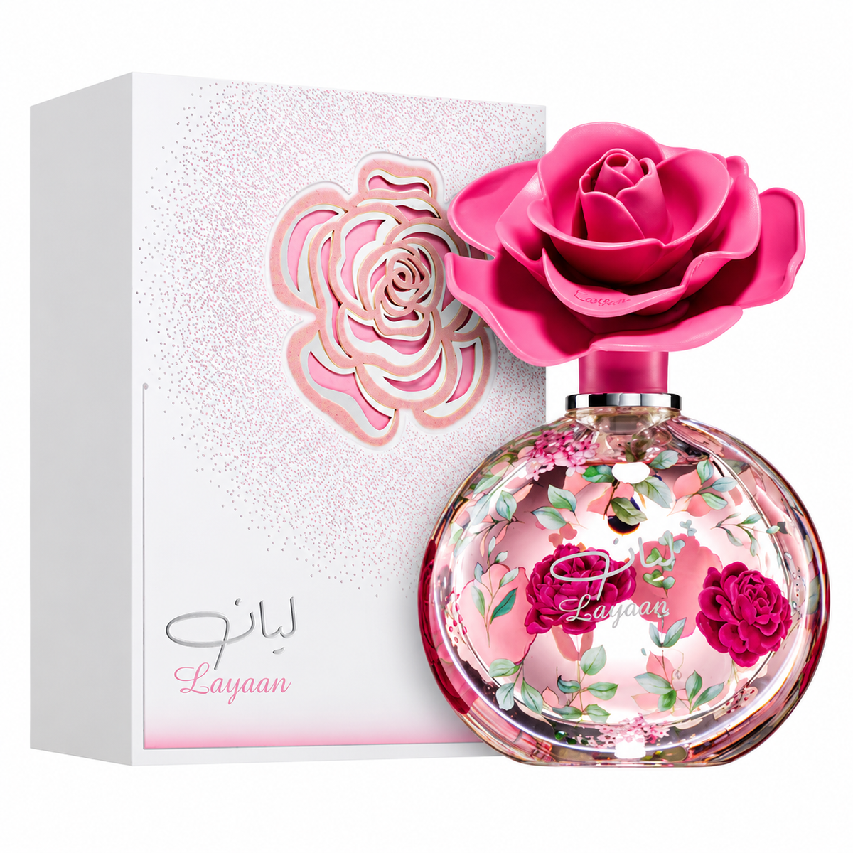 Perfume Layaan con frasco redondo de motivos florales y tapón de rosa fucsia junto a su caja original sobre fondo blanco.